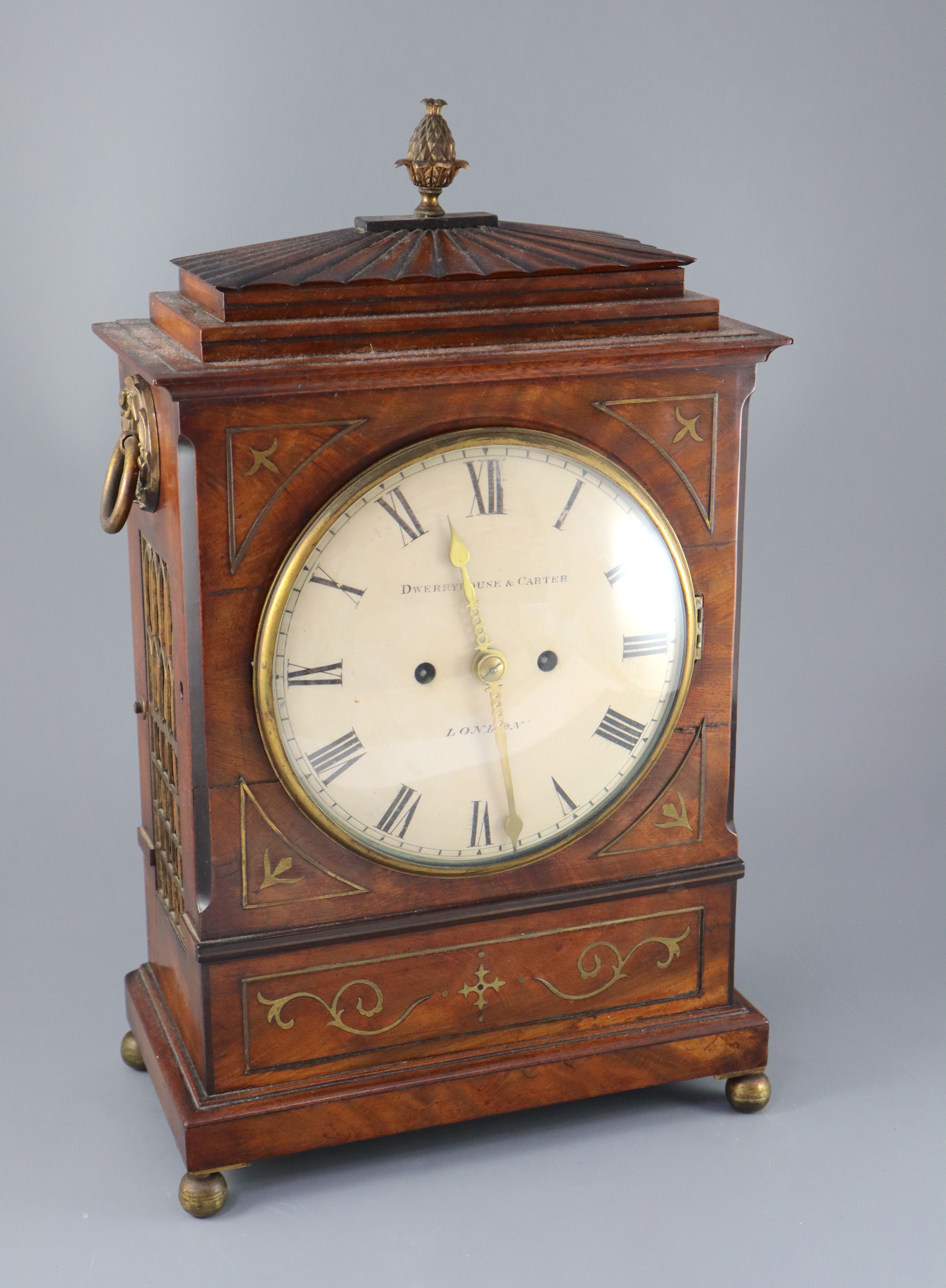 Dwerryhouse & Carter of London. A Regency brass inset mahogany mantel clock, height 19.5in.